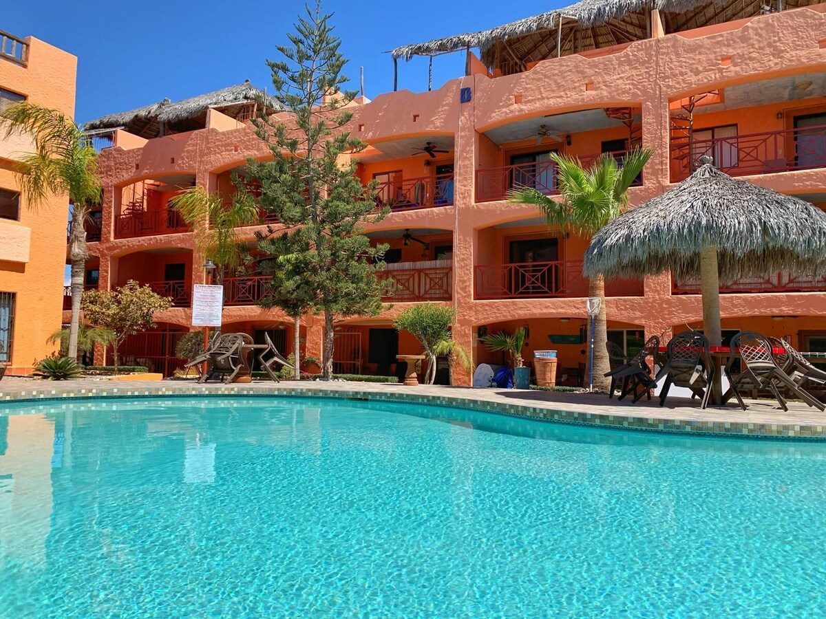 Swimming pool and shaded palapa at El Pueblo