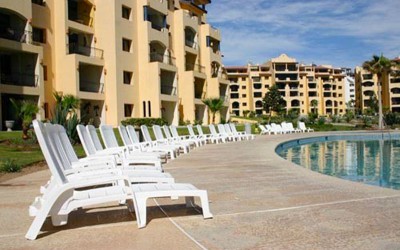 Poolside lounge chairs and condominium buildings